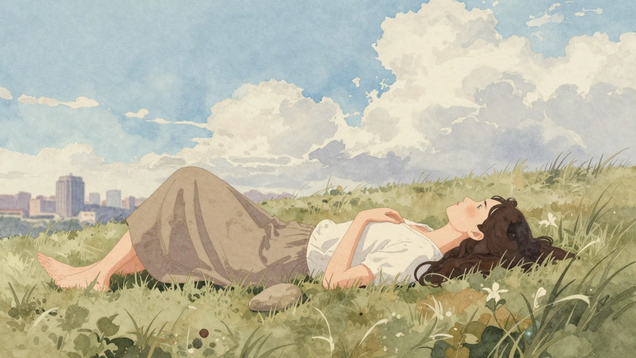 Woman lying on grass looking at clouds drifting across a soft blue sky.