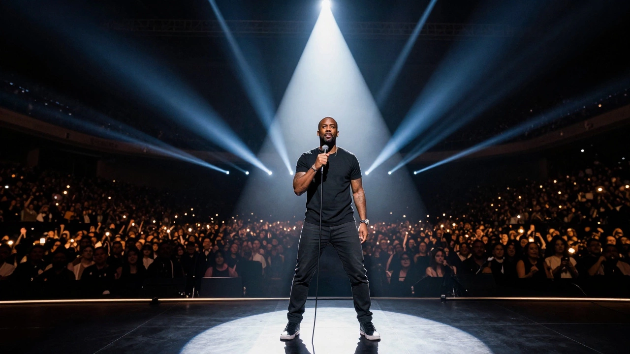 Comedian on stage with vast audience silhouettes, highlighting massive stadium tour scale.