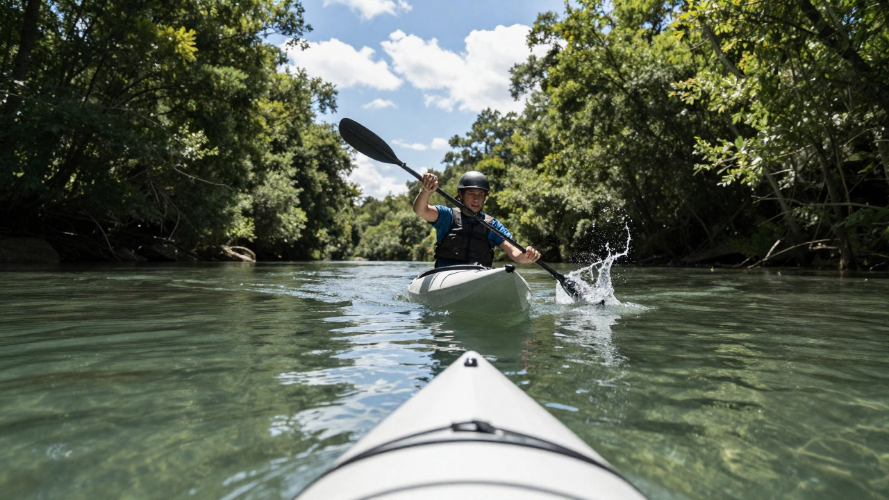 Person kayaking on a calm river surrounded by woods