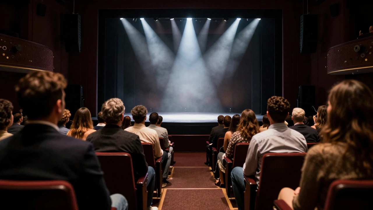 View from the audience looking towards a brightly lit Broadway stage during a performance, with attendees in the foreground dressed in neat, semi-formal clothing, capturing the immersive atmosphere of live theater.